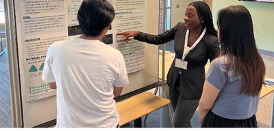 Photos for newsletterEWD 15.jpg Nelanne Bolima from the University of Maryland Baltimore County (UMBC) shares the results of her project during the REM poster session.